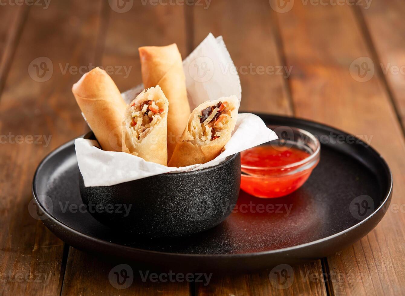 Crispy Vegetable Spring Rolls with Sweet Chili Dipping Sauce in plate side view of Asian Appetizer photo