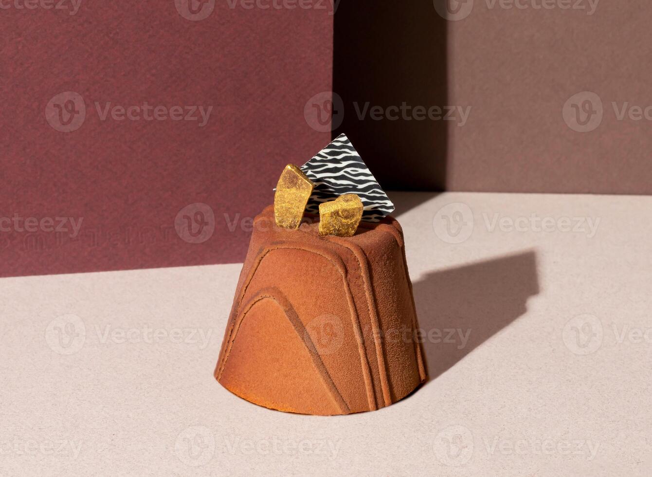 Low Sugar Bitter Chocolate Mousse Cake with Gold Flakes isolated on background side view of patisserie concepts photo