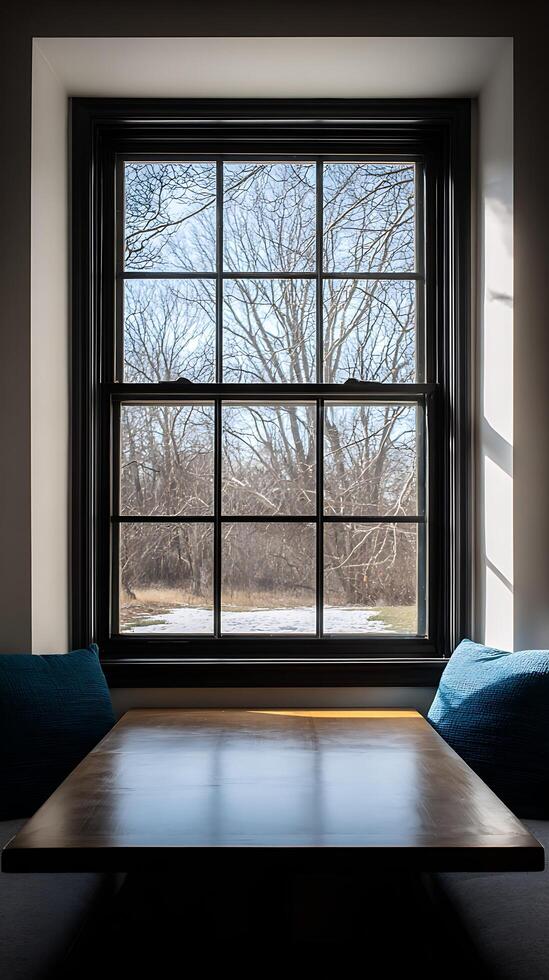 Cozy Window Seat Overlooking a Snowy Landscape with Bare Trees. photo