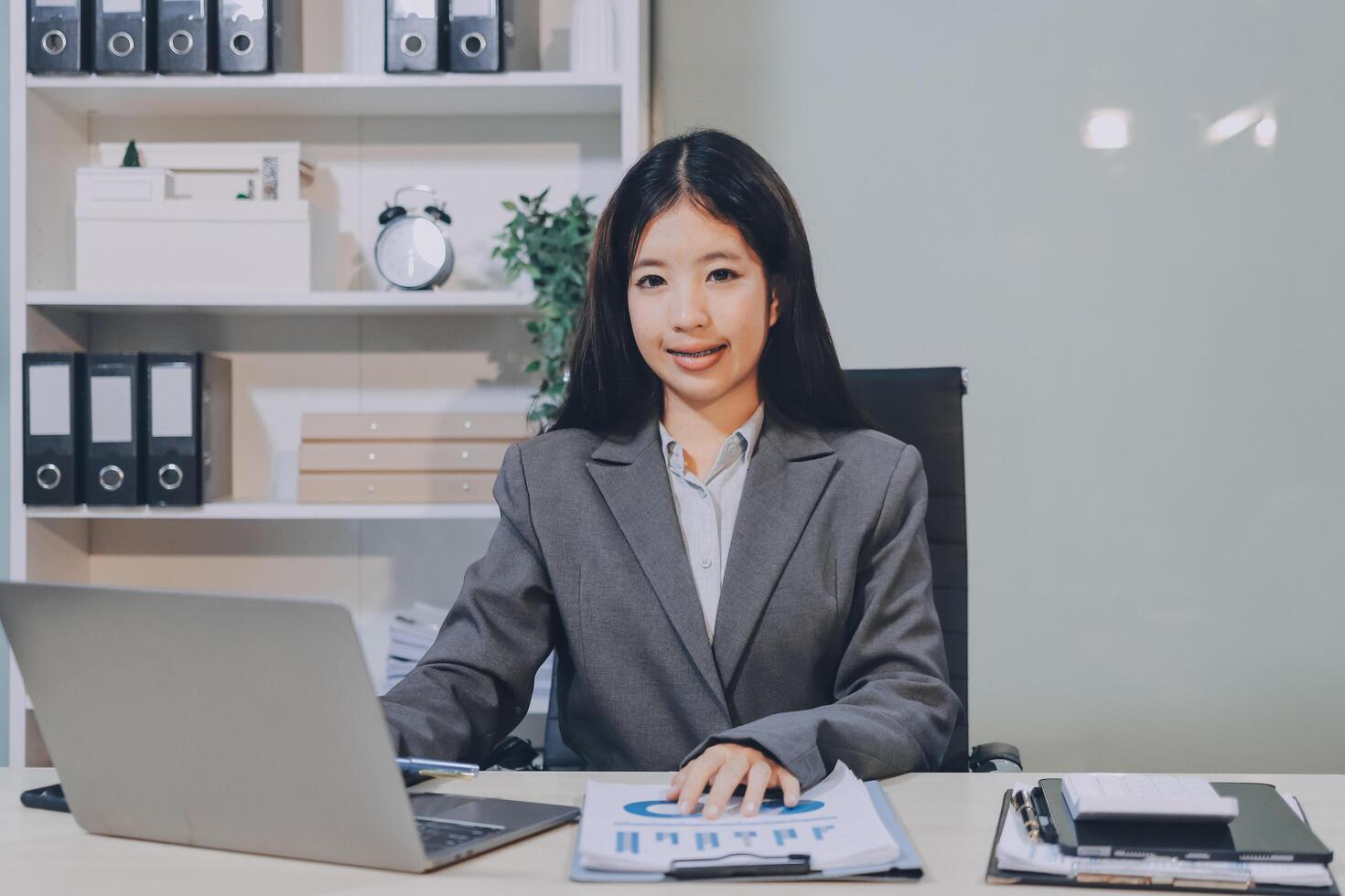 Asian business woman working at desk with laptop photo