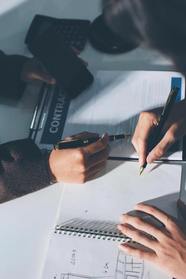 Two people working on a contract at a desk photo