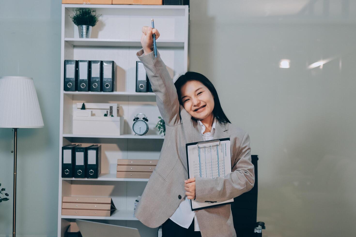 Asian businesswoman holding up her hands in the office photo