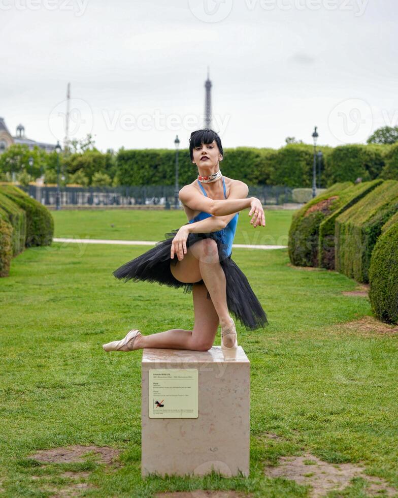 Ballet dancer in elegant pose with Eiffel Tower view photo