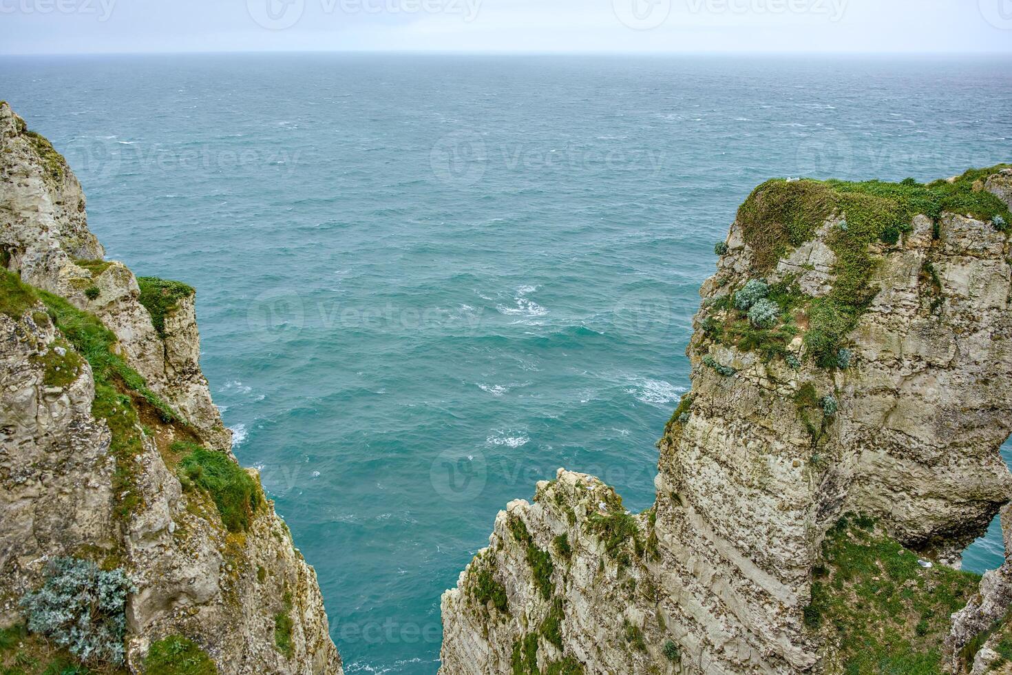 Rock cliffs and endless ocean horizon in Etretat, Normandy photo
