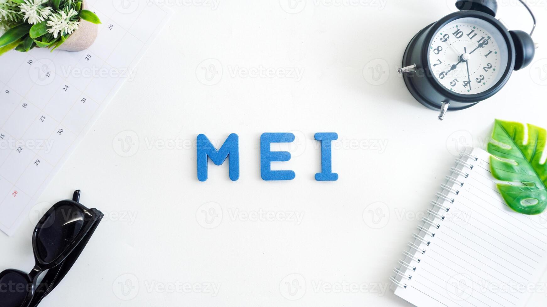 Flat lay composition with blue color foam letters spelling word Mei isolated on white background photo