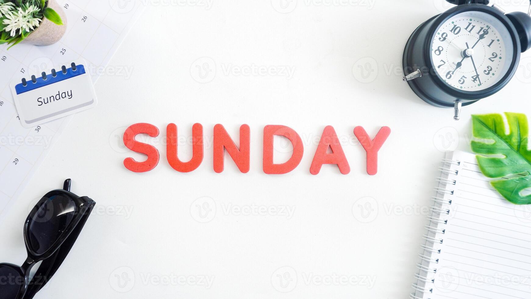 Flat lay composition with red color foam letters spelling word SUNDAY isolated on white background photo