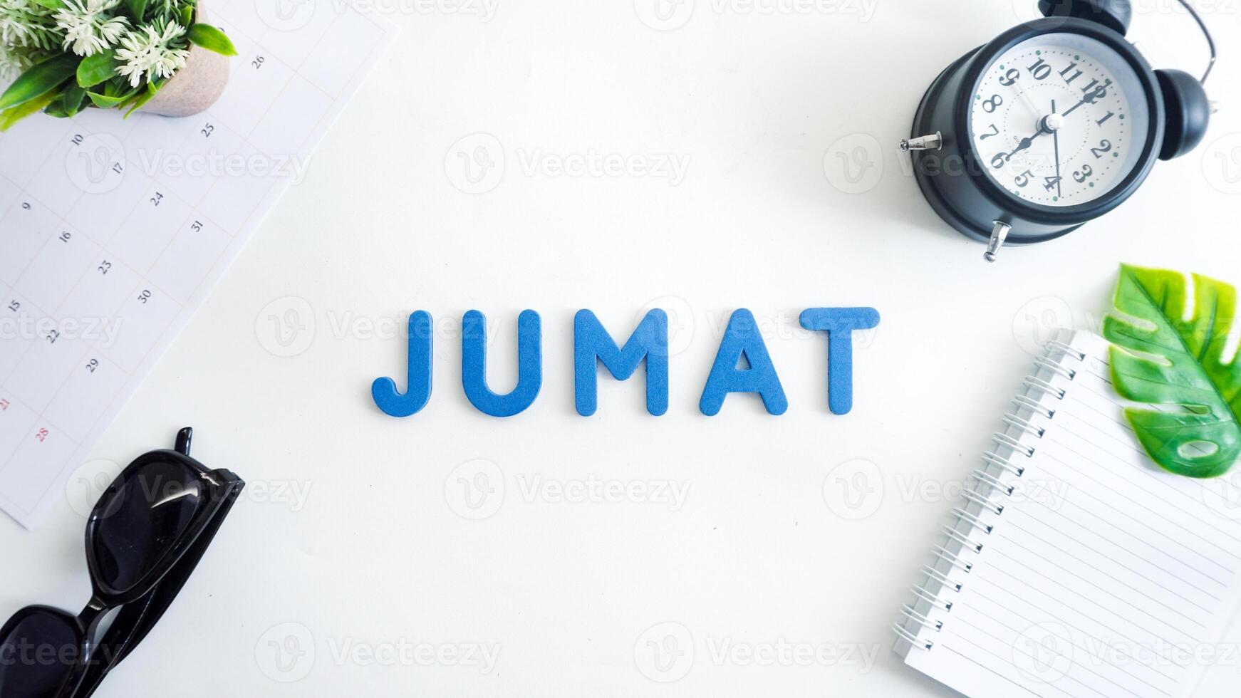 Flat lay composition with blue color foam letters spelling word friday in Indonesian, JUMAT isolated on white background photo