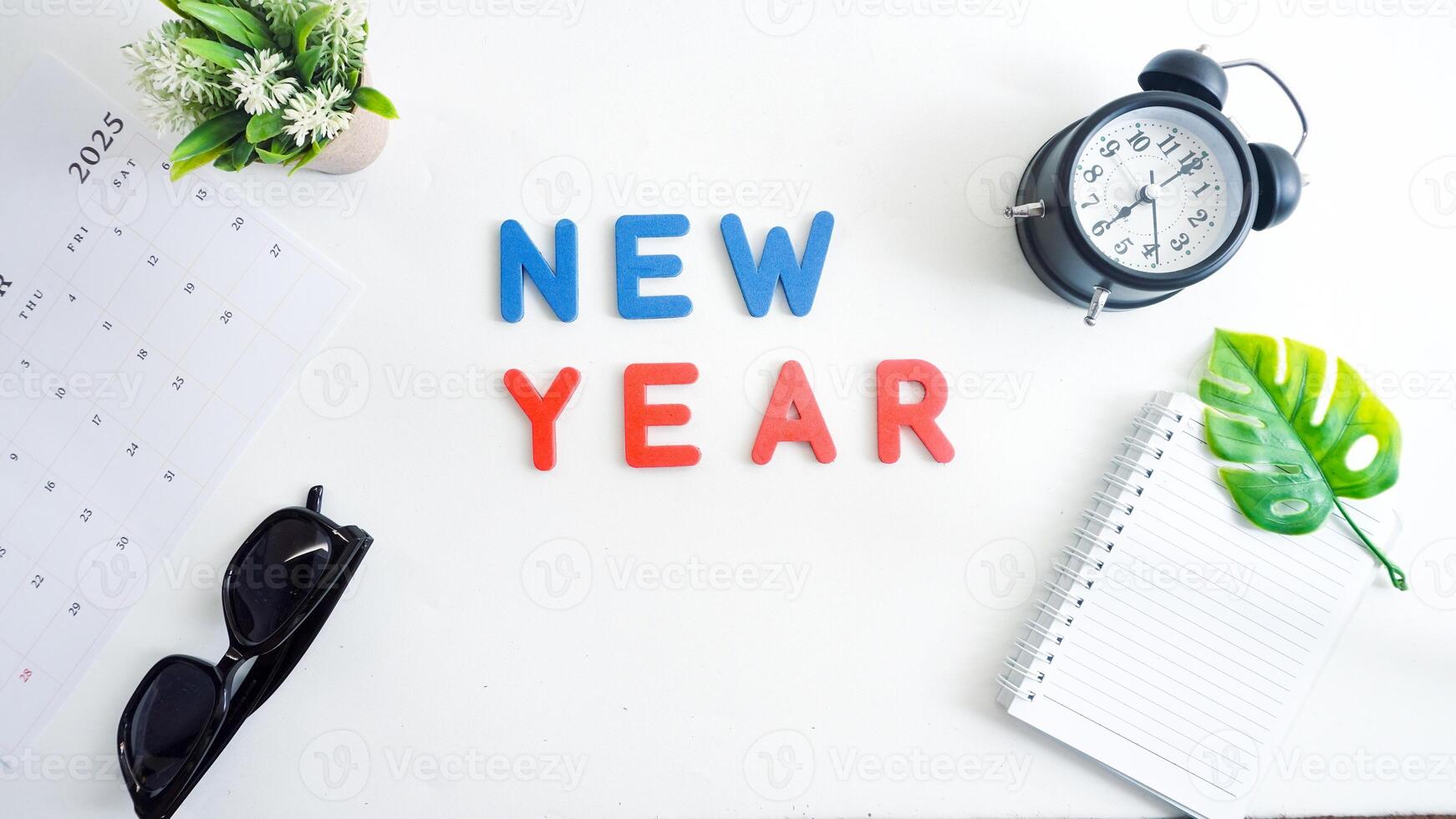 Flat lay composition with red and blue color foam letters spelling word NEW YEAR isolated on white background photo