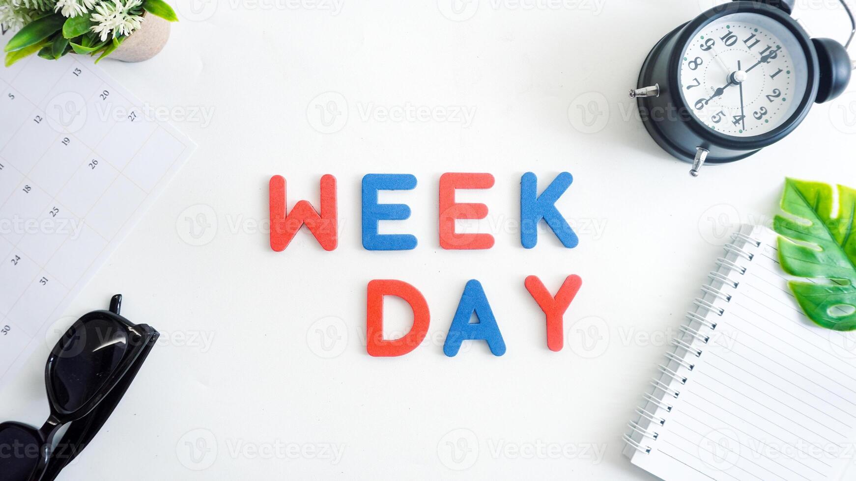 Flat lay composition with blue and red color foam letters spelling word WEEKDAY isolated on white background photo