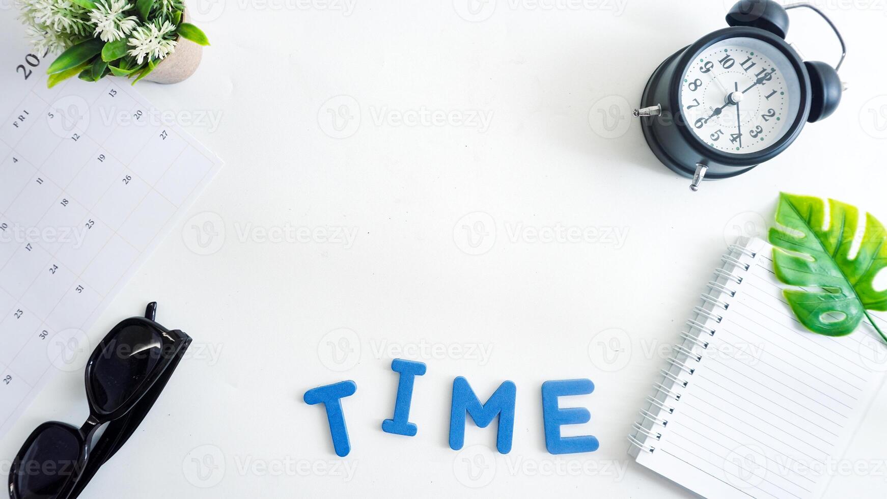 Flat lay composition with blue color foam letters spelling text TIME isolated on white background photo