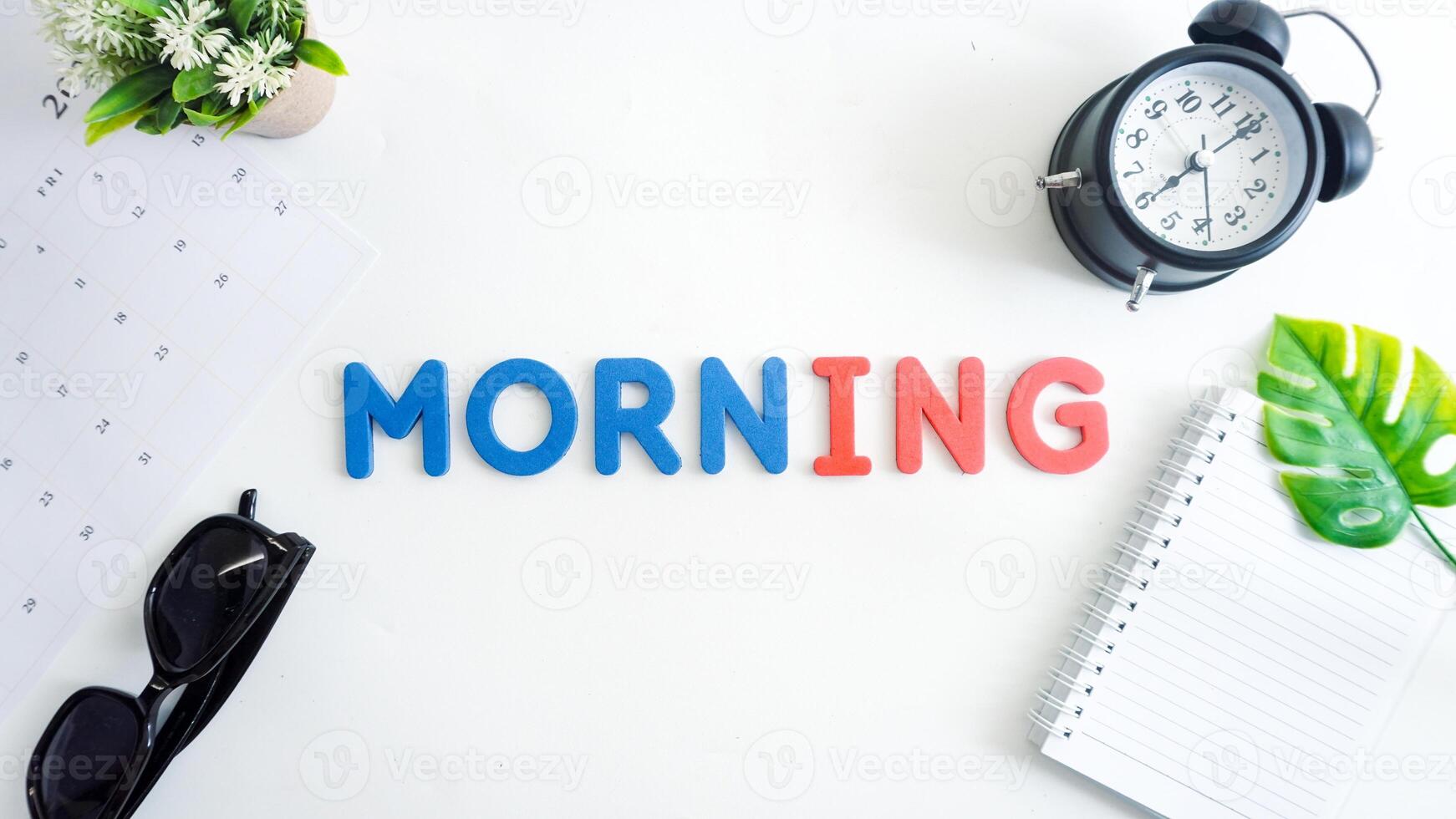 Flat lay composition with blue and red color foam letters spelling word MORNING isolated on white background photo