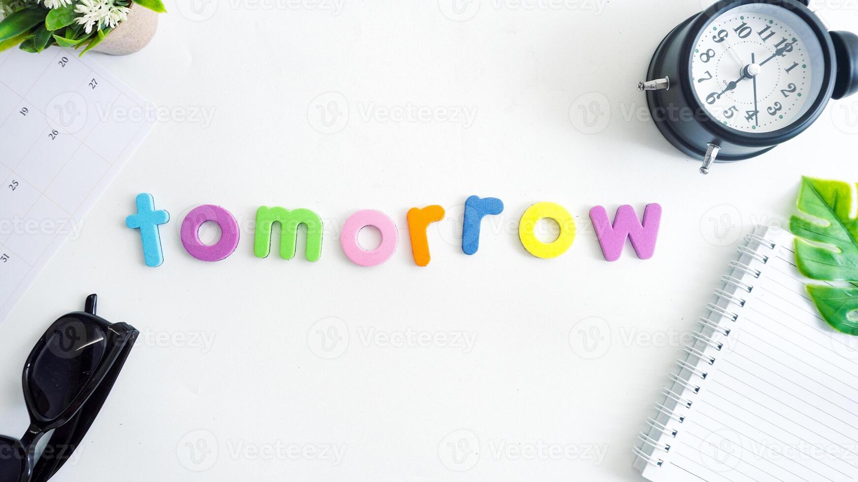 Flat lay composition with colorful foam letters spelling word TOMORROW isolated on white background photo
