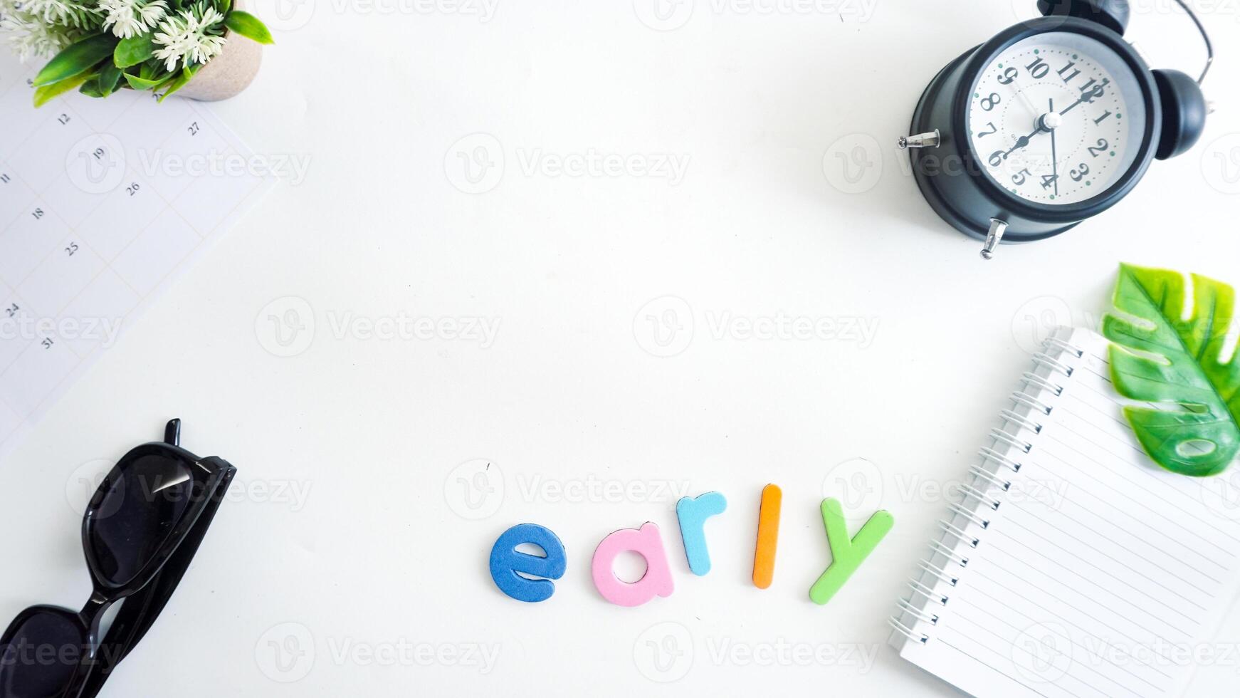 Flat lay composition with colorful foam letters spelling word EARLY isolated on white background photo