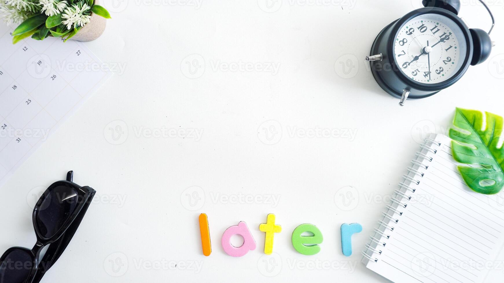 Flat lay composition with colorful foam letters spelling text LATER isolated on white background photo