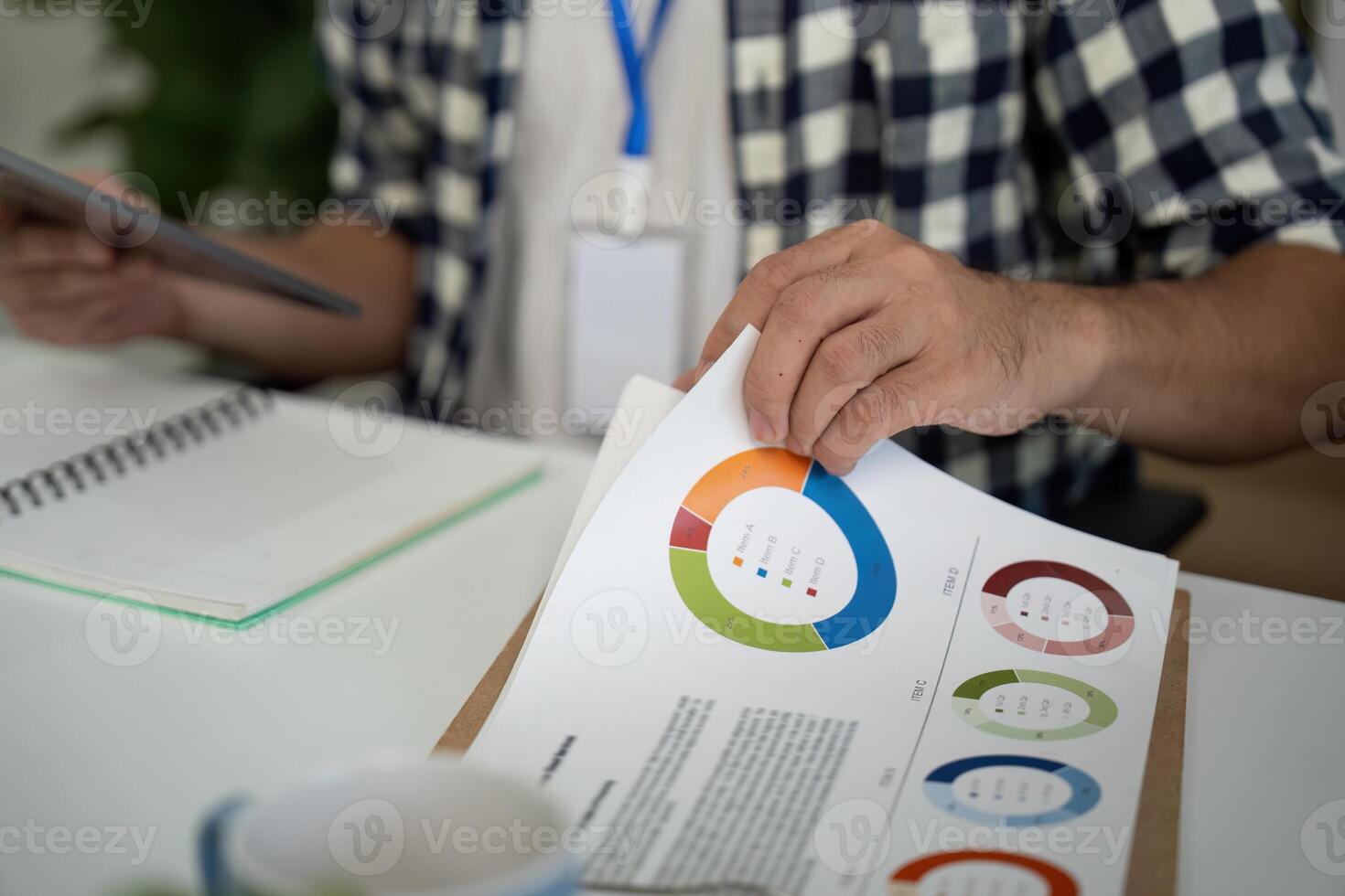 Data Analysis. Professional reviewing colorful charts and graphs in a modern office. photo