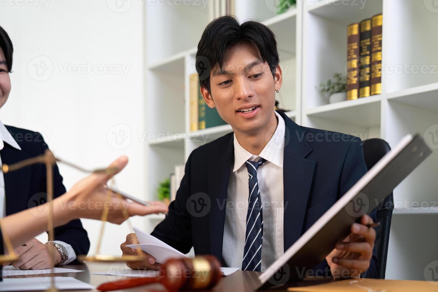 Young Lawyer Analyzing Case Files with Colleagues photo