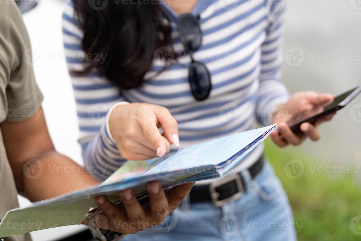 Couple planning their next adventure with a map photo