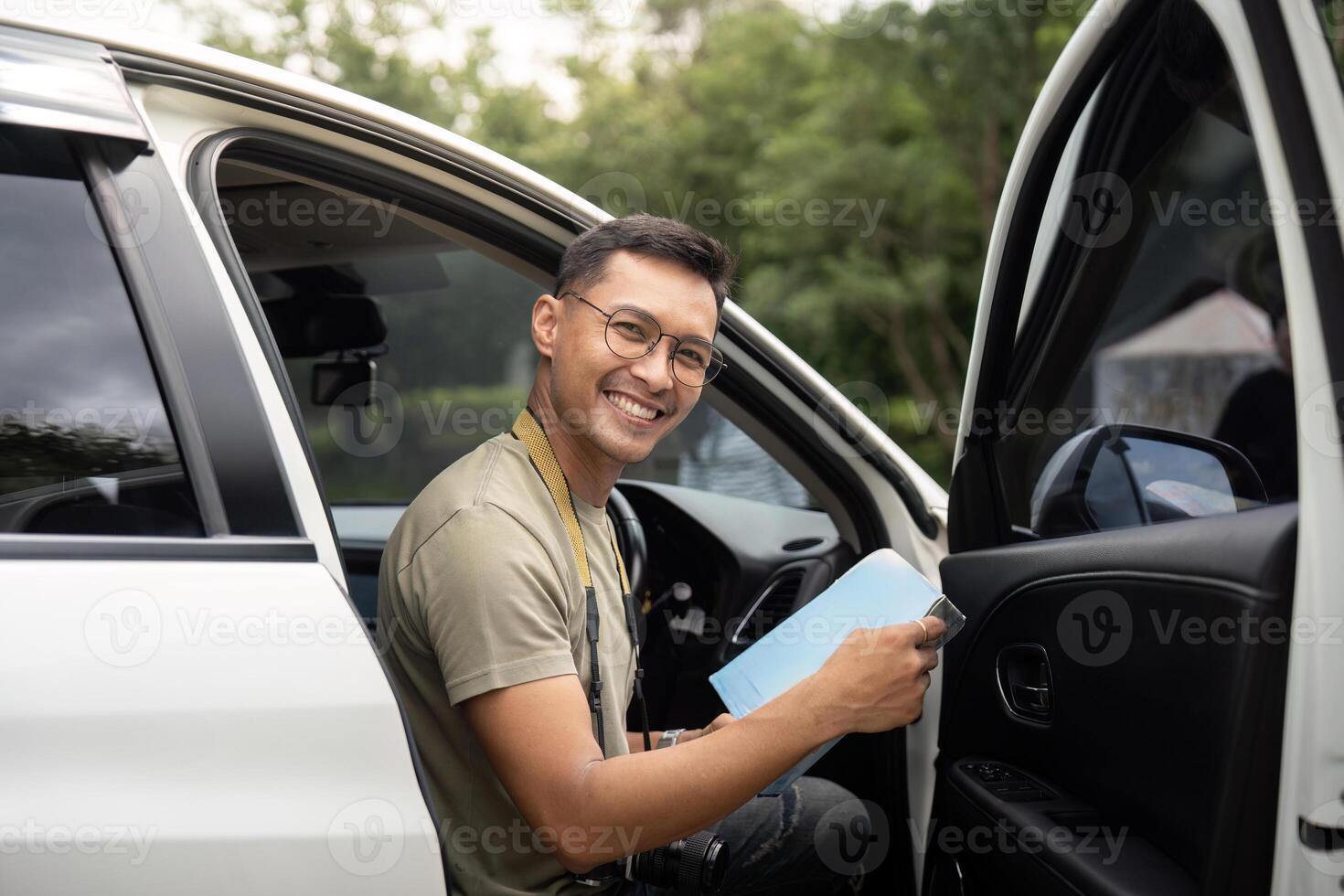 Young man smiling while sitting in a car photo