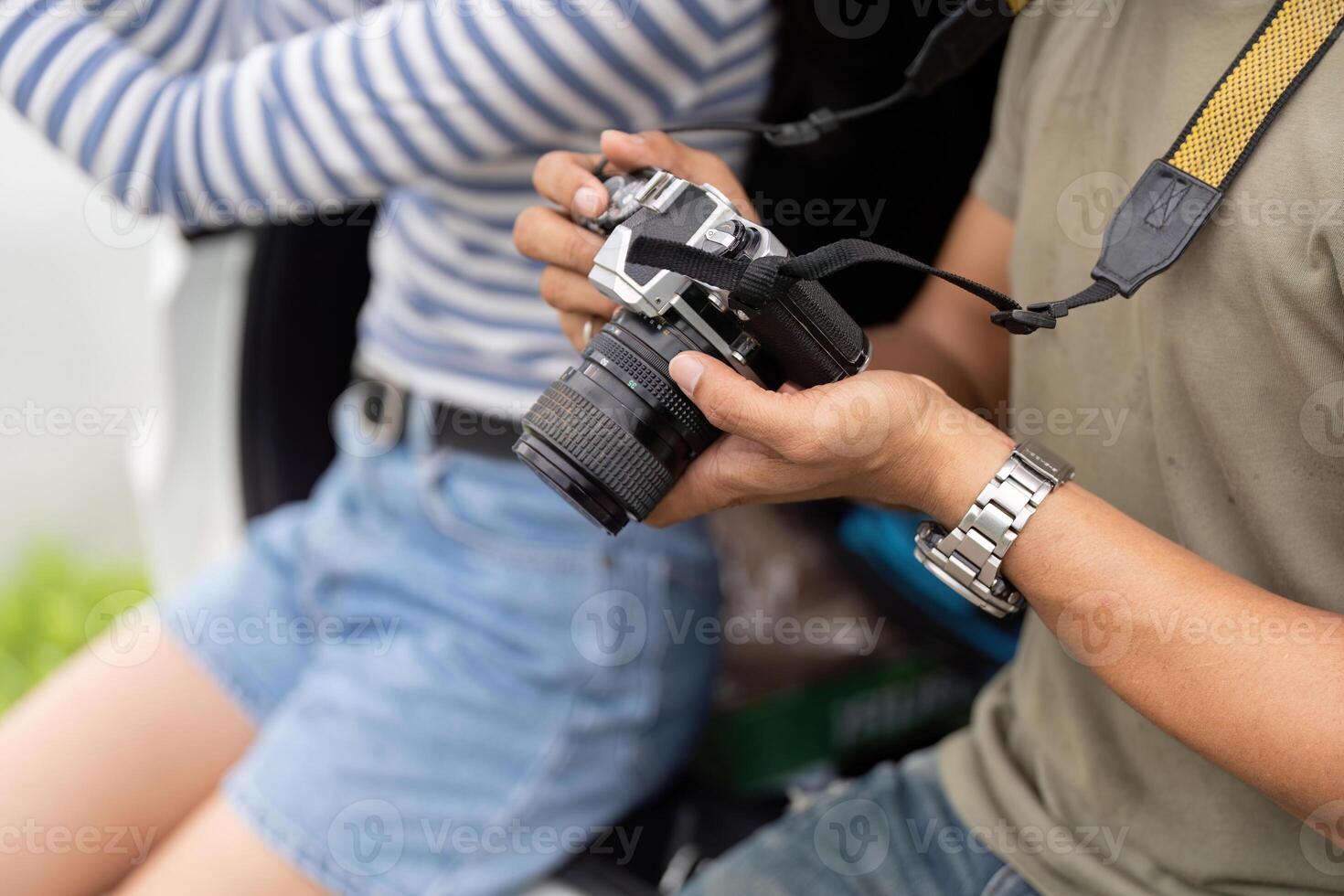 Couple capturing memories with a camera during a road trip photo