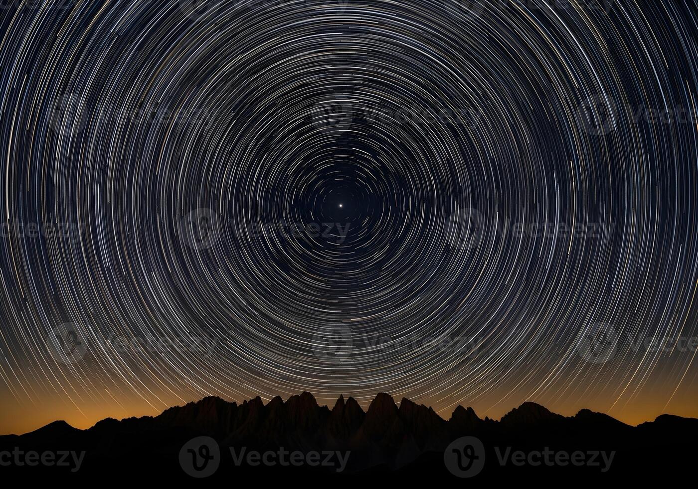 star trails over mountains at night photo