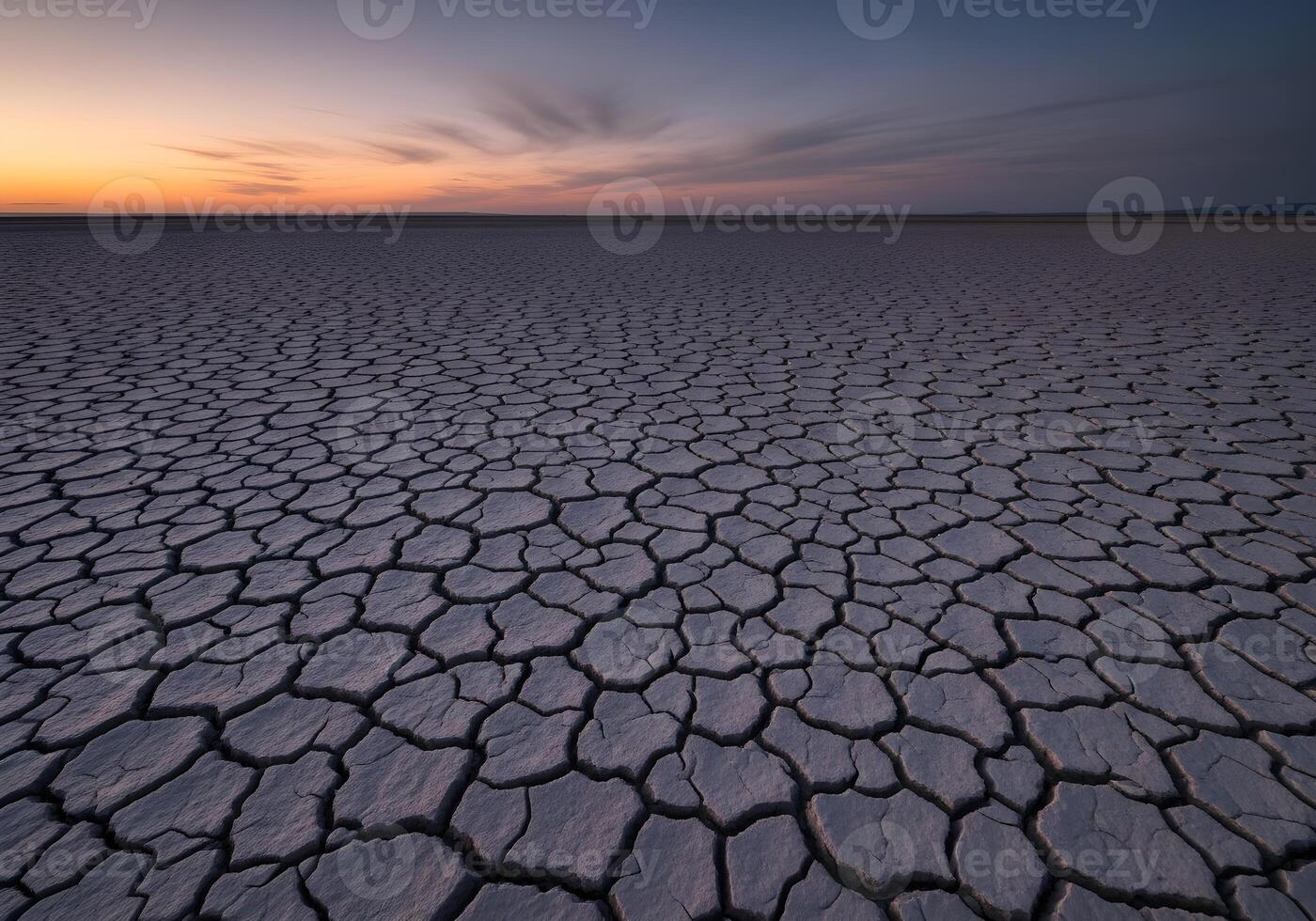 Cracked Desert Floor at Twilight with Earth Texture photo