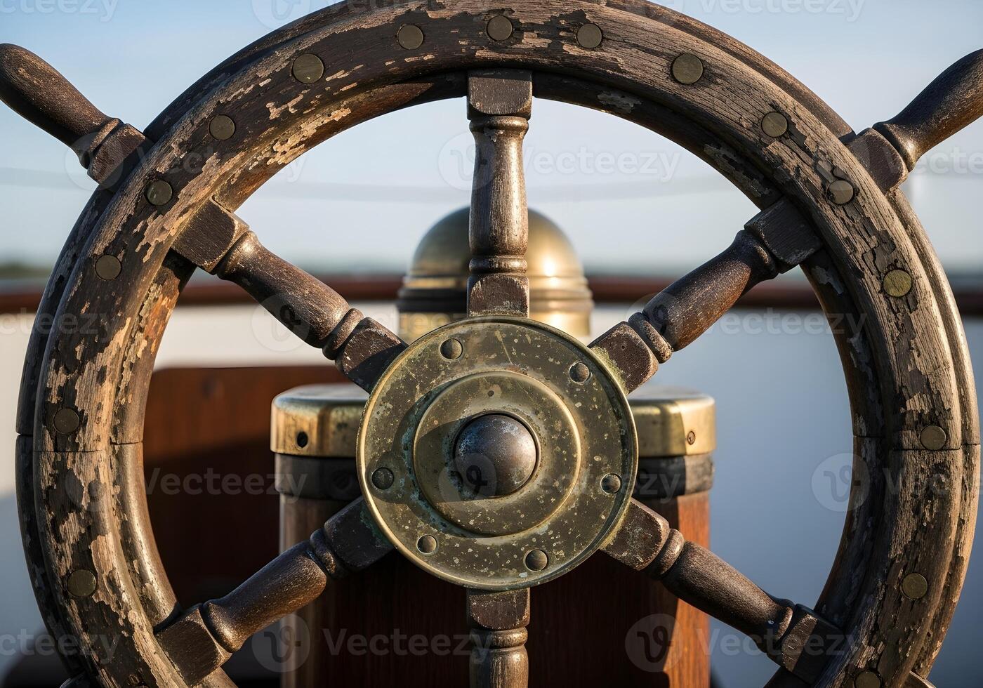 A close up of the steering wheel on a boat photo