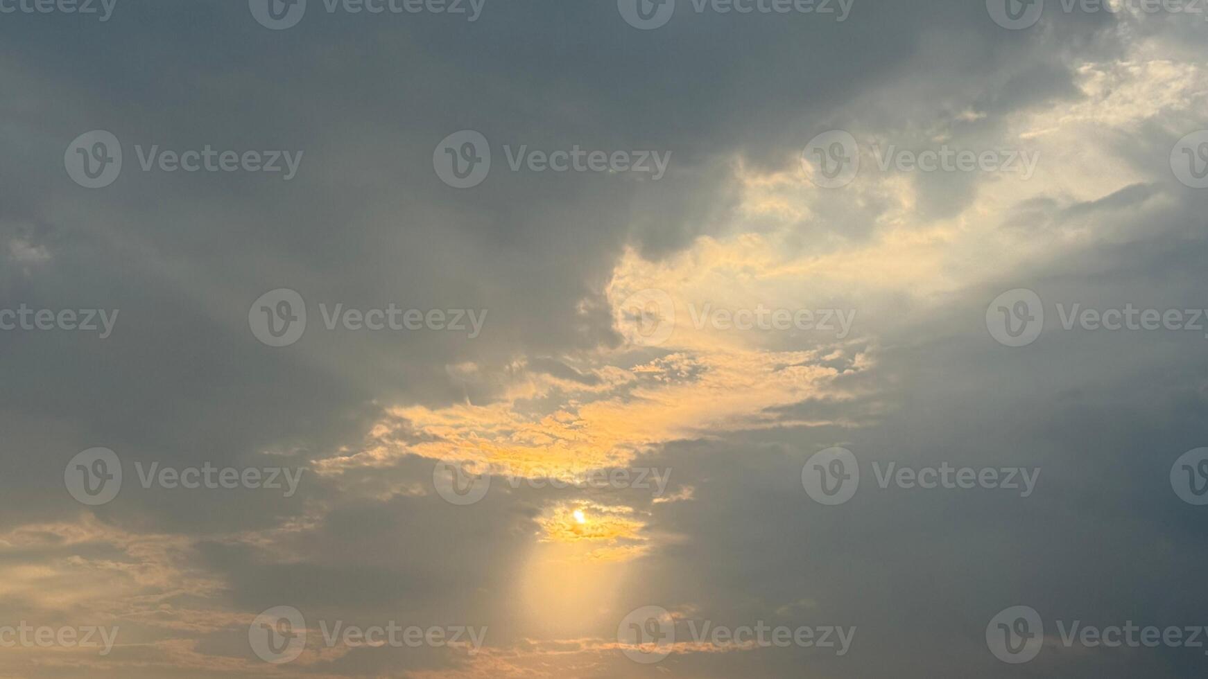 Radiant sunbeams dramatically illuminate cloudy sky, creating beautiful and ethereal atmospheric perspective photo
