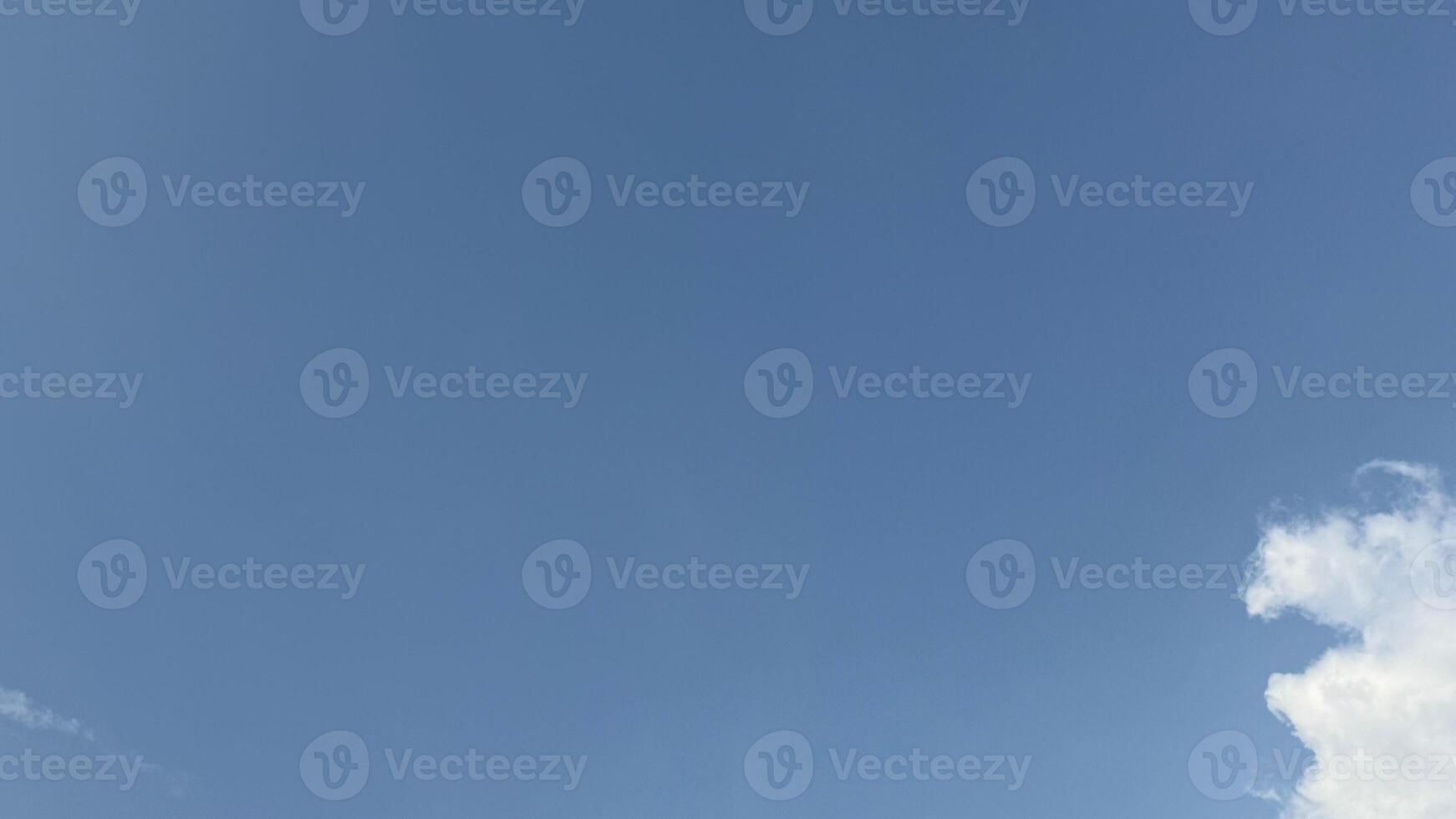 Serene blue sky showcases pristine cloud on a bright day, conveying open space photo