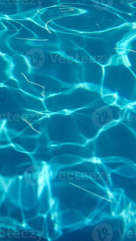 Rippling azure waves dance in sunlit patterns, reminiscent of midsummer dreams, inviting tranquility and introspection during World Oceans Day photo