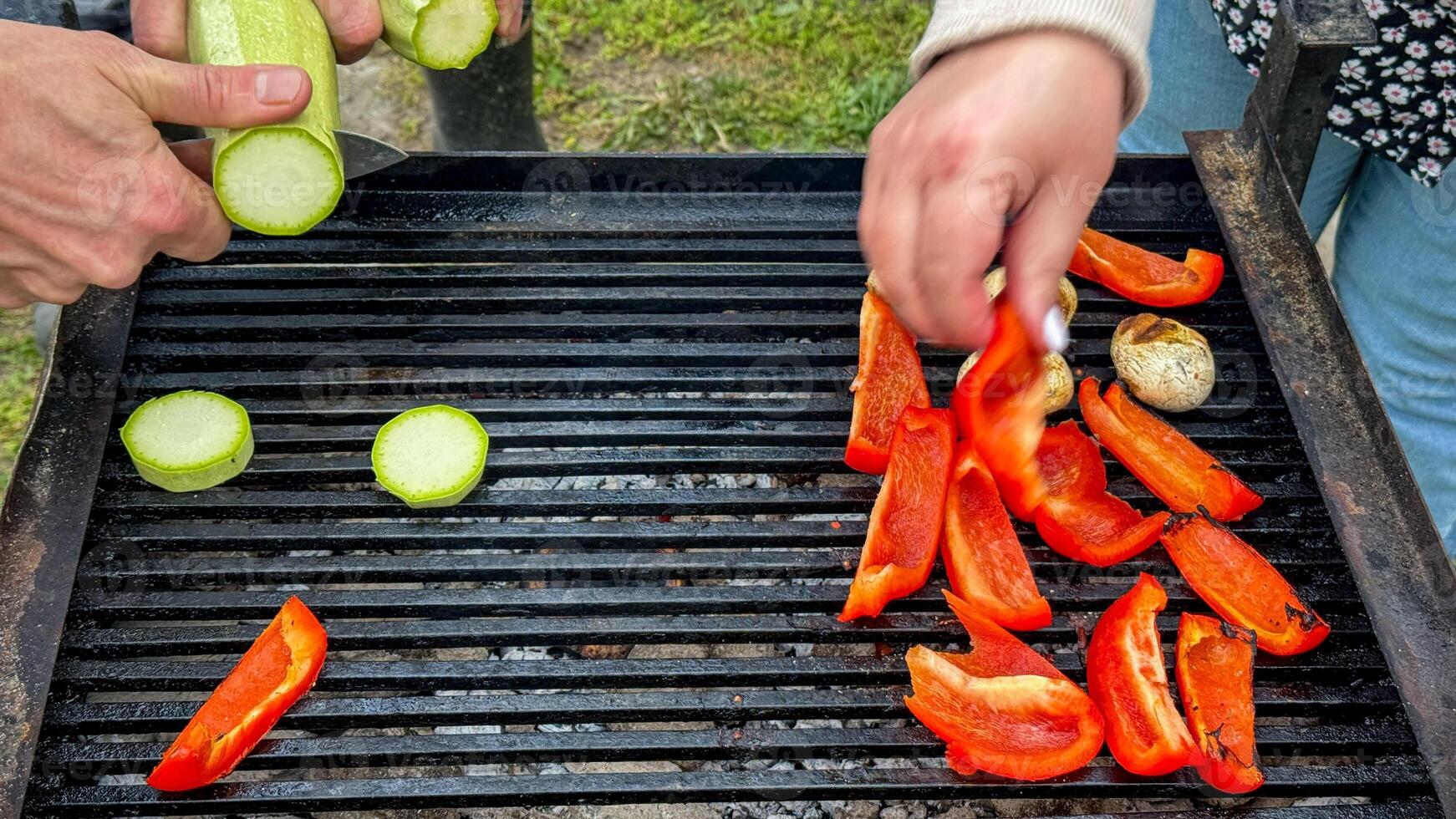 Grilled peppers and zucchini slices sizzling, rustic open air picnic, vibrant veggie fest, midsummer solstice feast, multicultural gathering photo