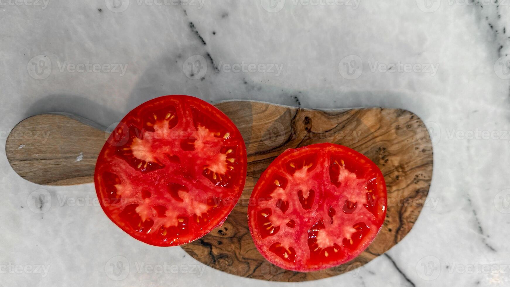 Sliced ruby tomatoes on rustic olive wood evoke Mediterranean harvest, summer solstice festivities, and organic garden abundance photo