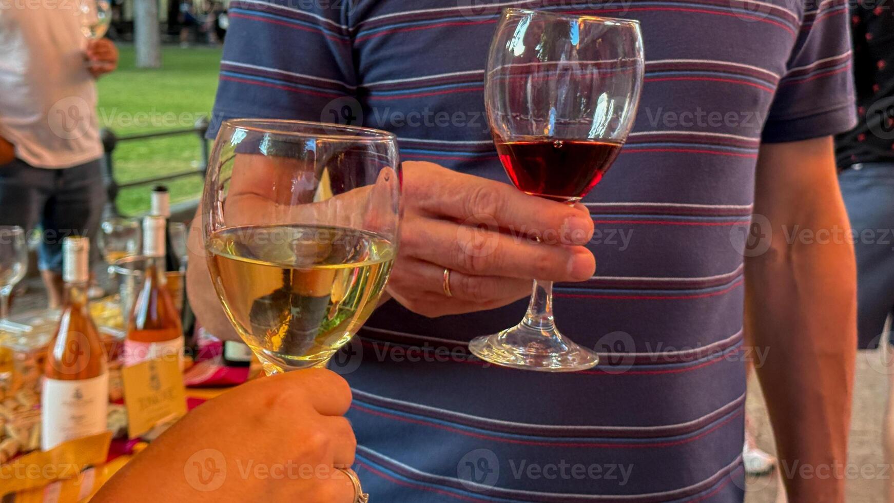 Toasting glasses under twilights embrace, celebrating Festivus with red nectar and golden elixir, diverse camaraderie, spontaneous jubilation photo