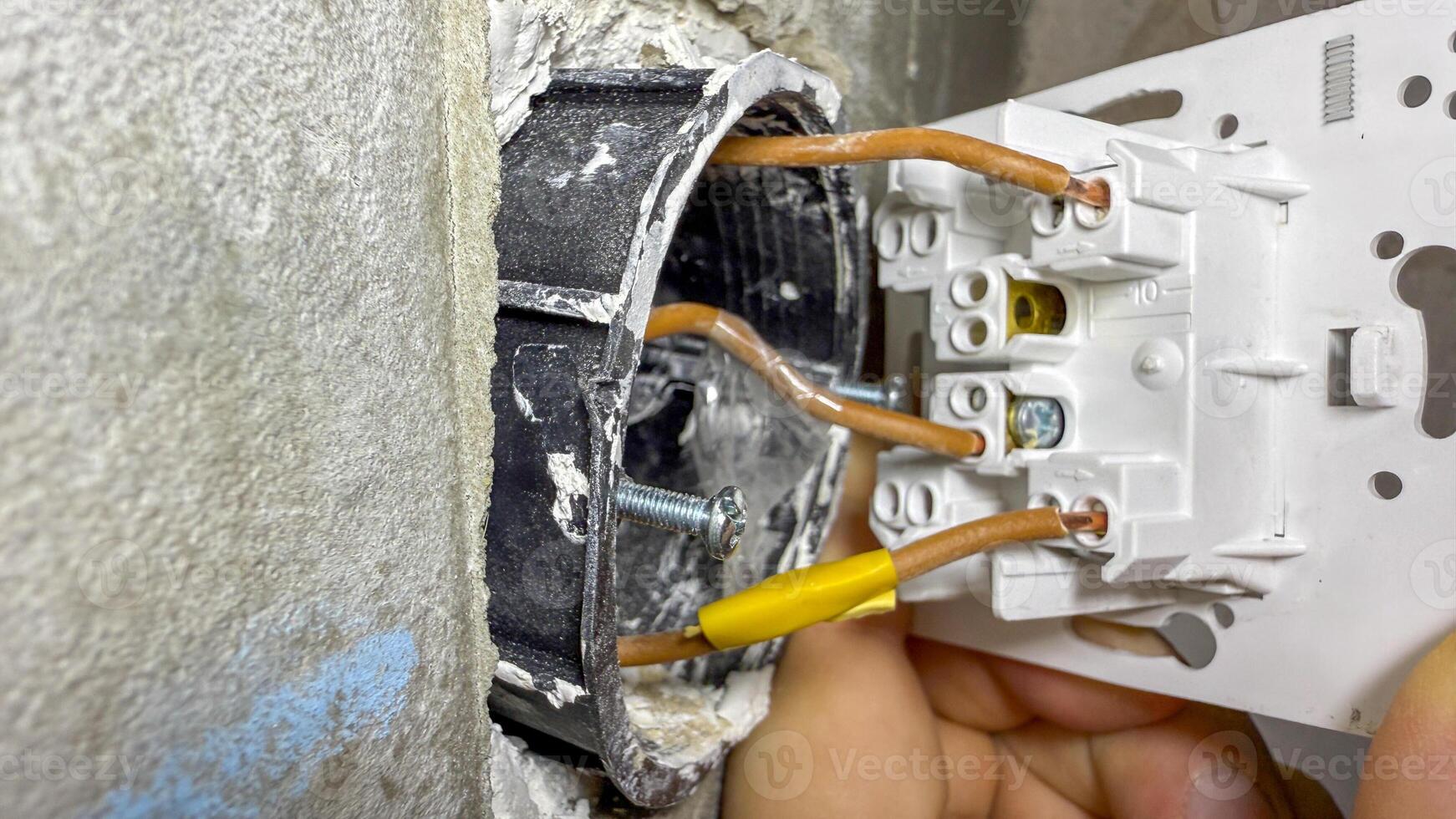 A hand deftly rewires a socket, conjuring sparks of innovation, reminiscent of International Repair Days DIY spirit photo