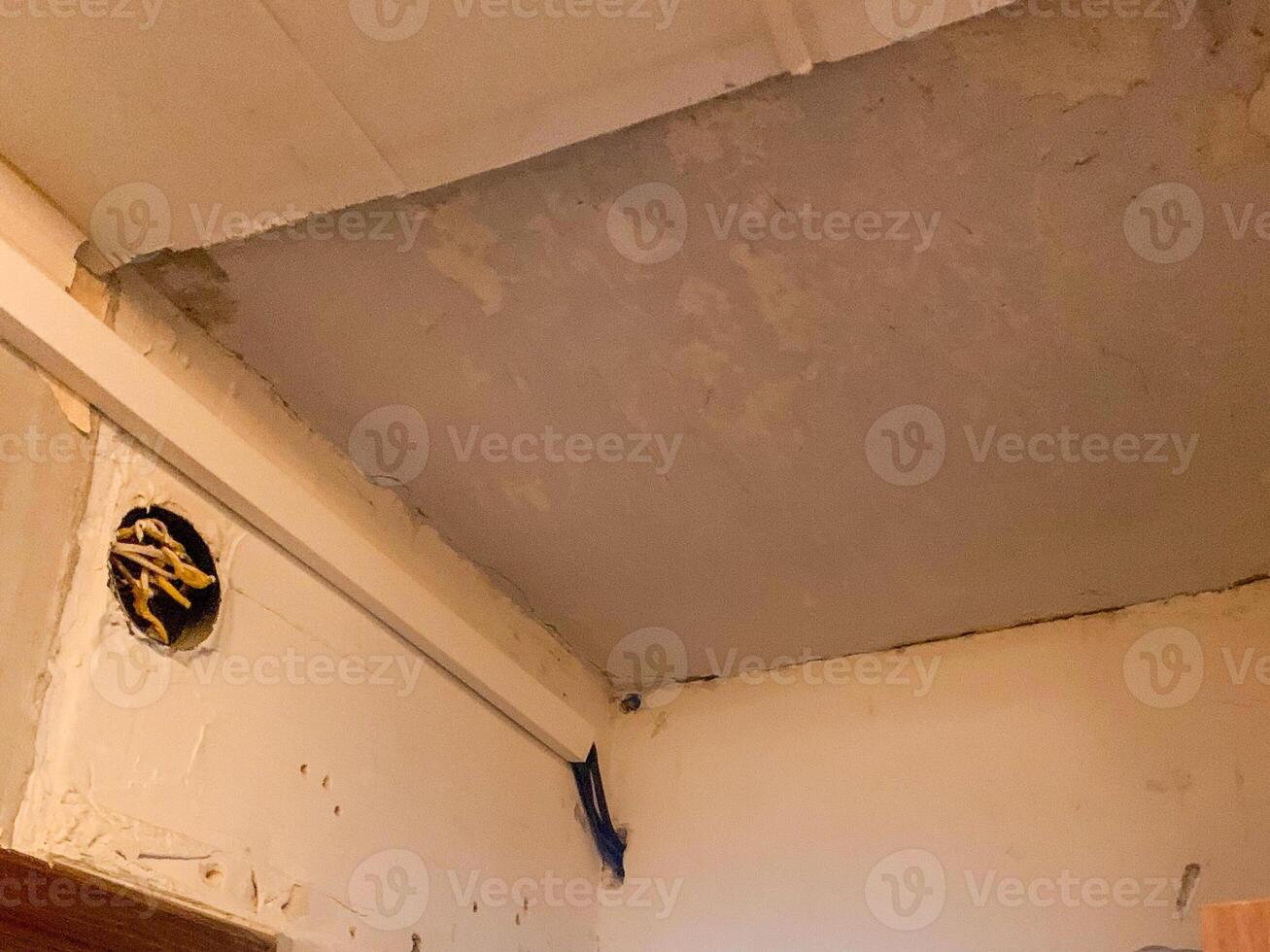 Rustic ceiling corner with peeling paint, evoking vintage charm ideal for Retro Renovation Day or artistic photo exhibits