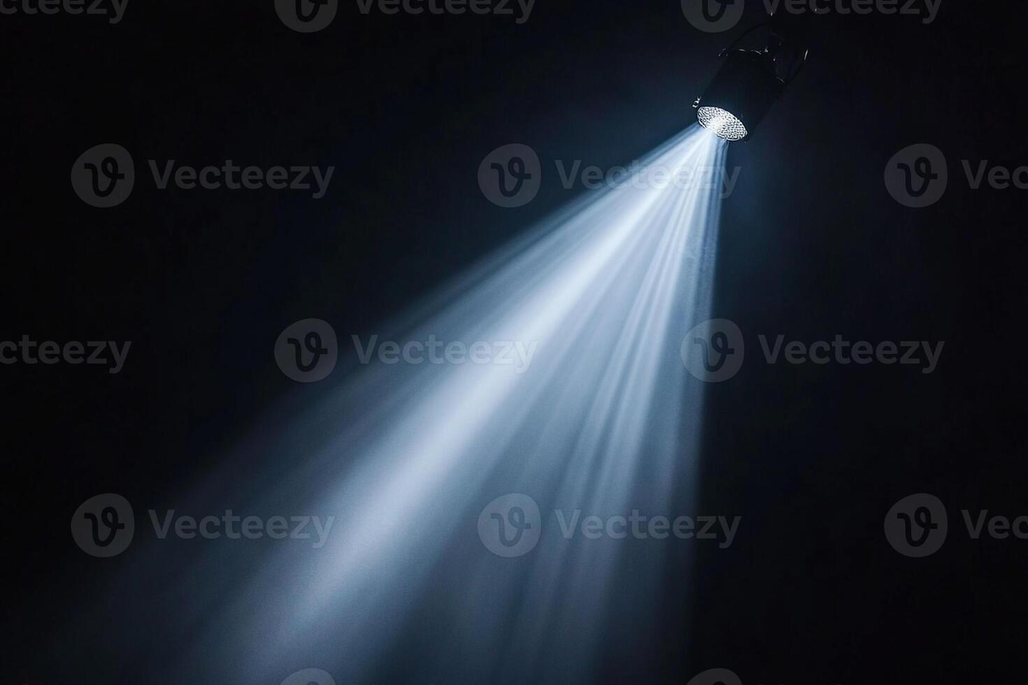 A spotlight is shining on a black background photo