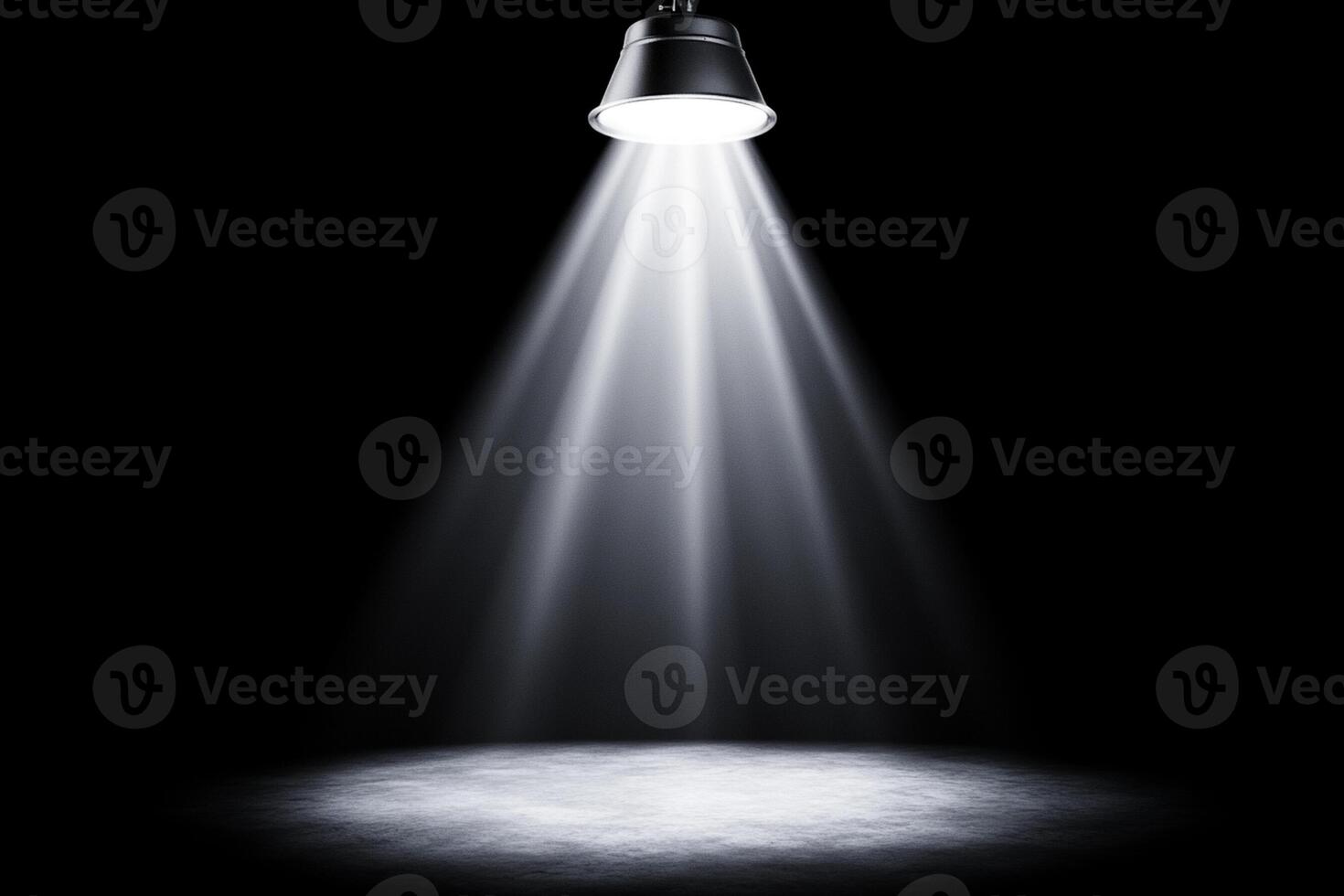 Light shining from a spotlight on a black background photo