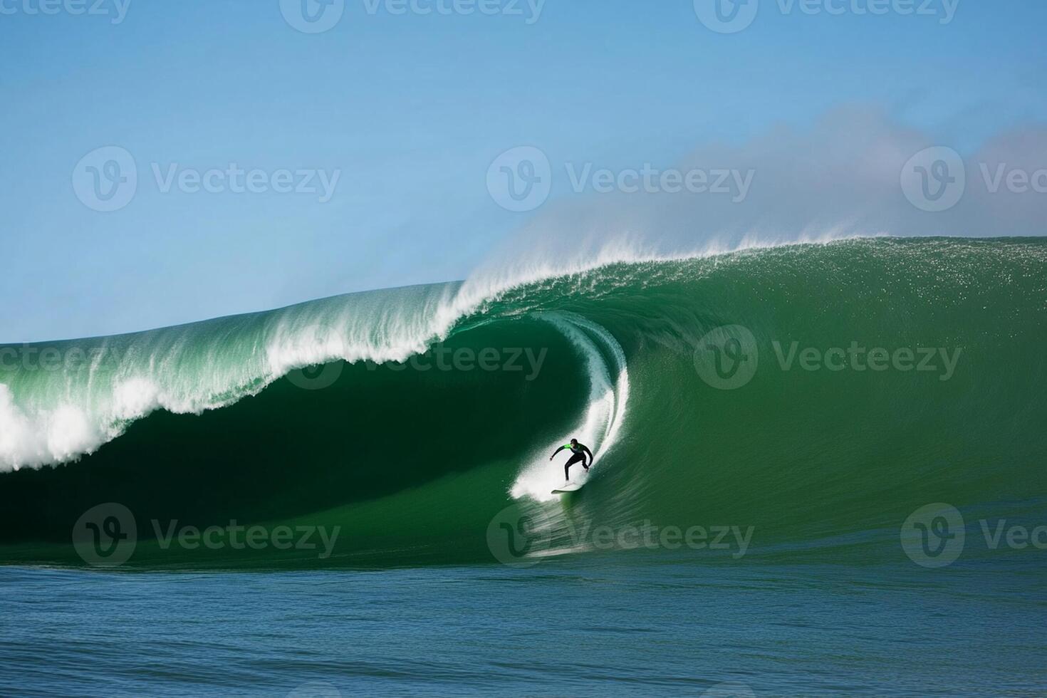 A man riding a large green wave on a surfboard photo
