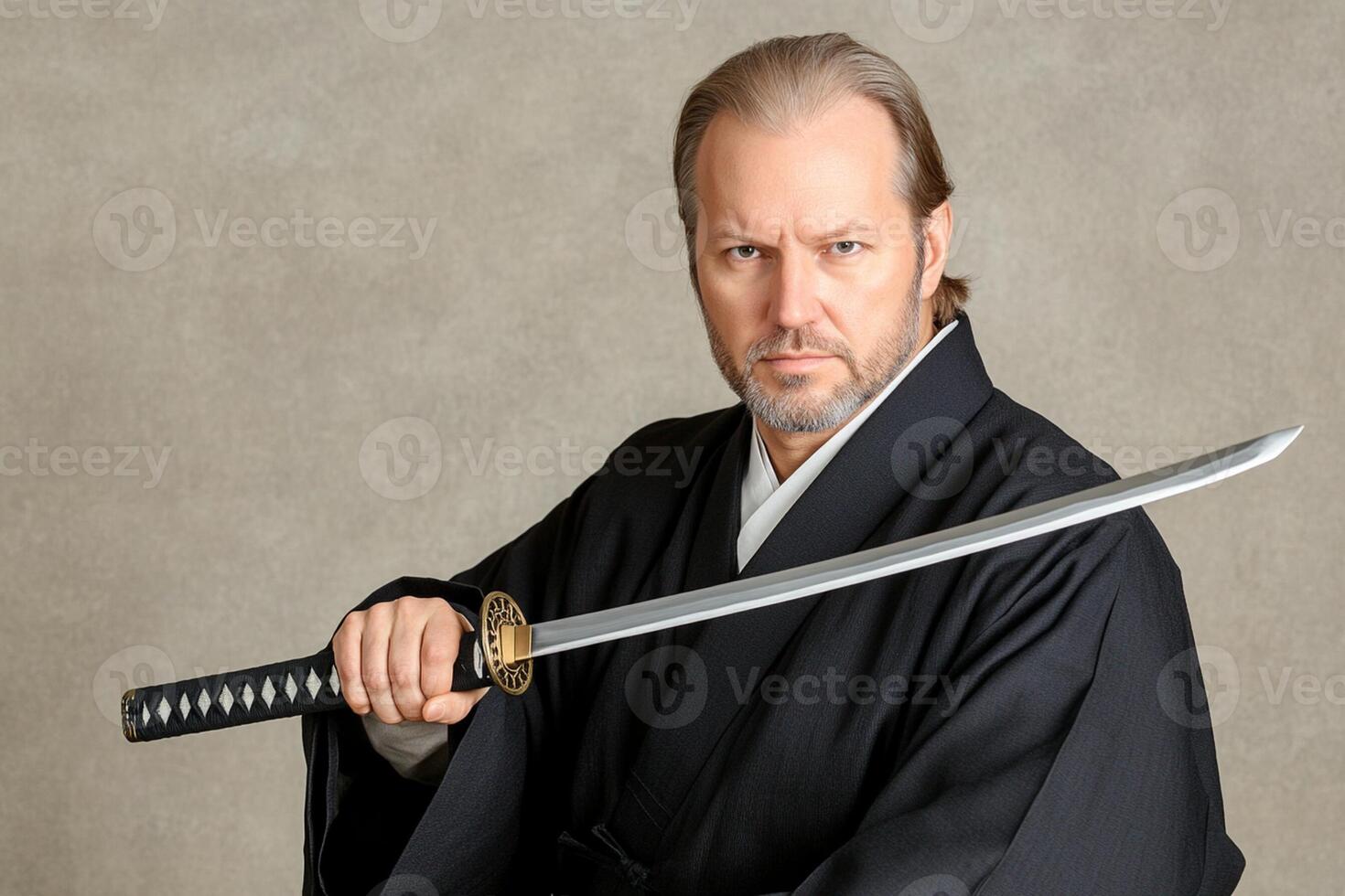 A man in a black robe holding a sword photo