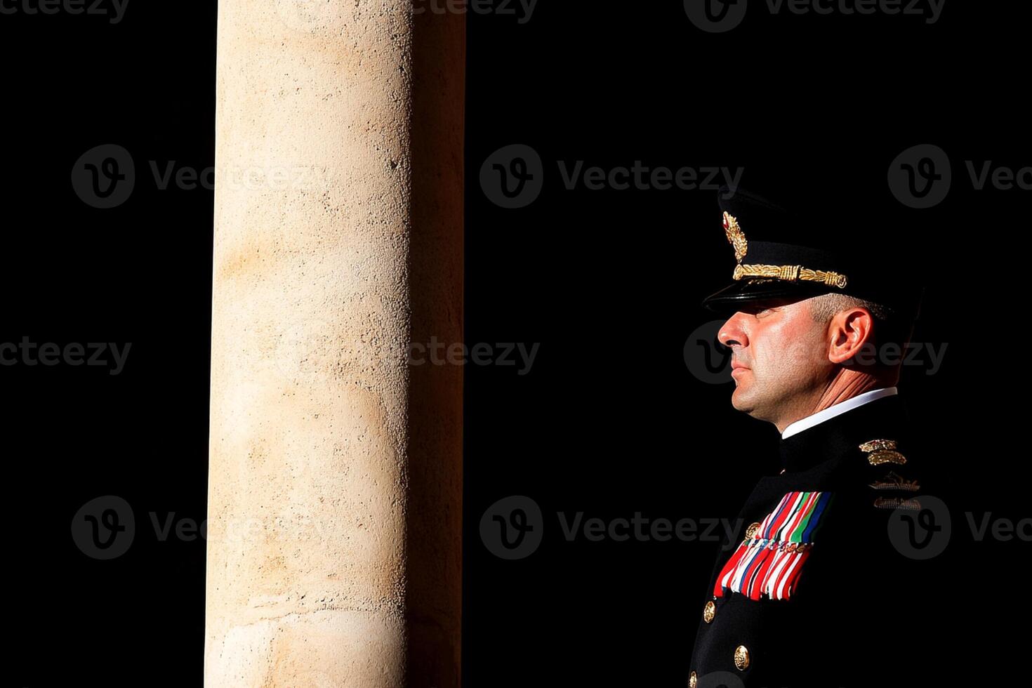 A man in uniform standing next to a pillar photo