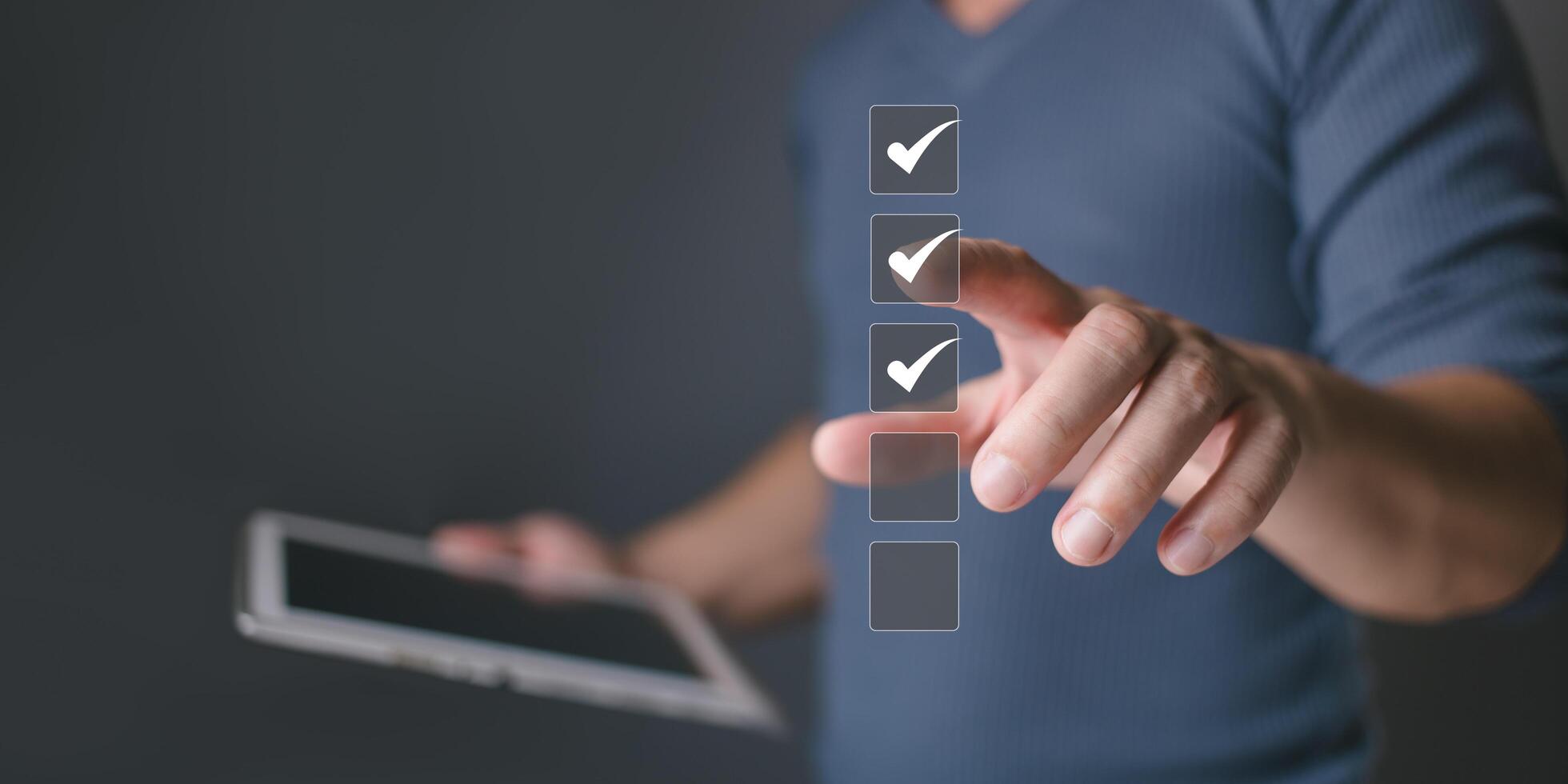 Businessman holding tablet and tapping checkbox, selecting online digital form for audit, quality control, voting, survey and evaluation with business success. photo