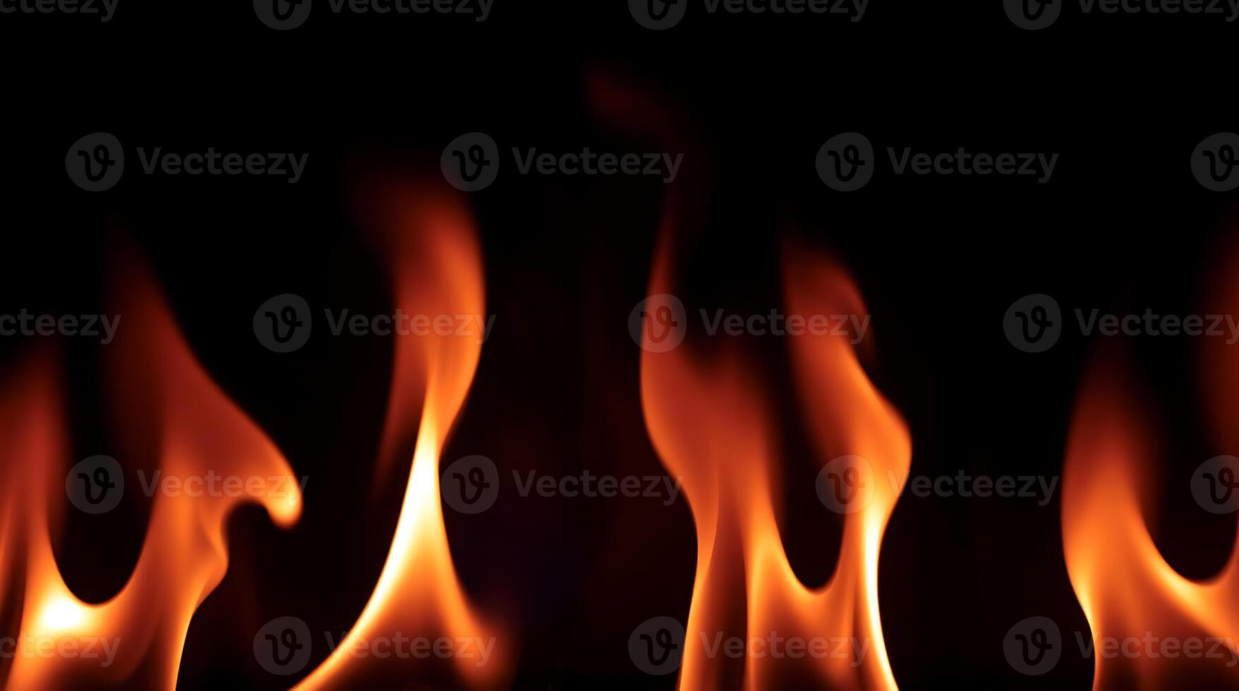 yellowy fire flames on a black background. photo