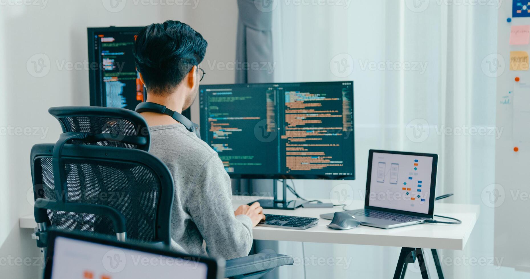 Young adult Asia male freelance typing write prompt AI bot IT app smart program nomad, game, terminal with coding, user interface, designer, big data center on desktop computer. photo