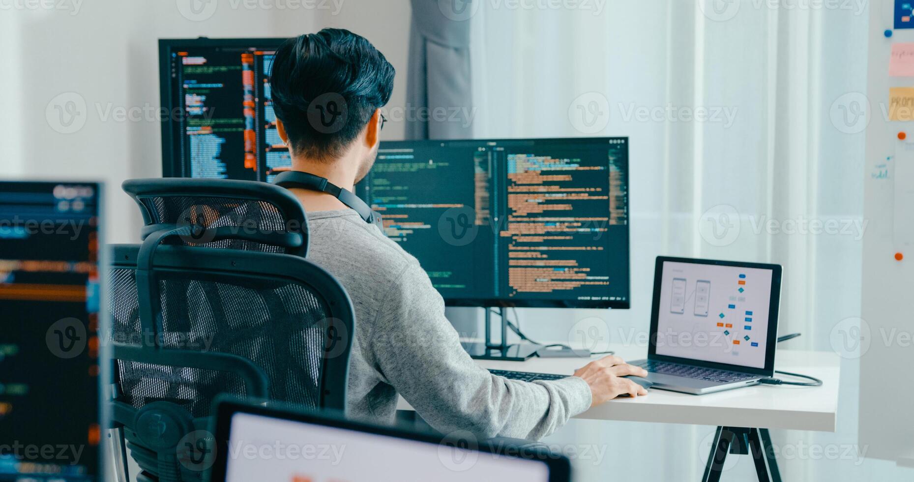 Young adult Asia male typing write prompt AI bot IT app smart program nomad, game, terminal with coding, user interface, designer, big data center on desktop computer. photo