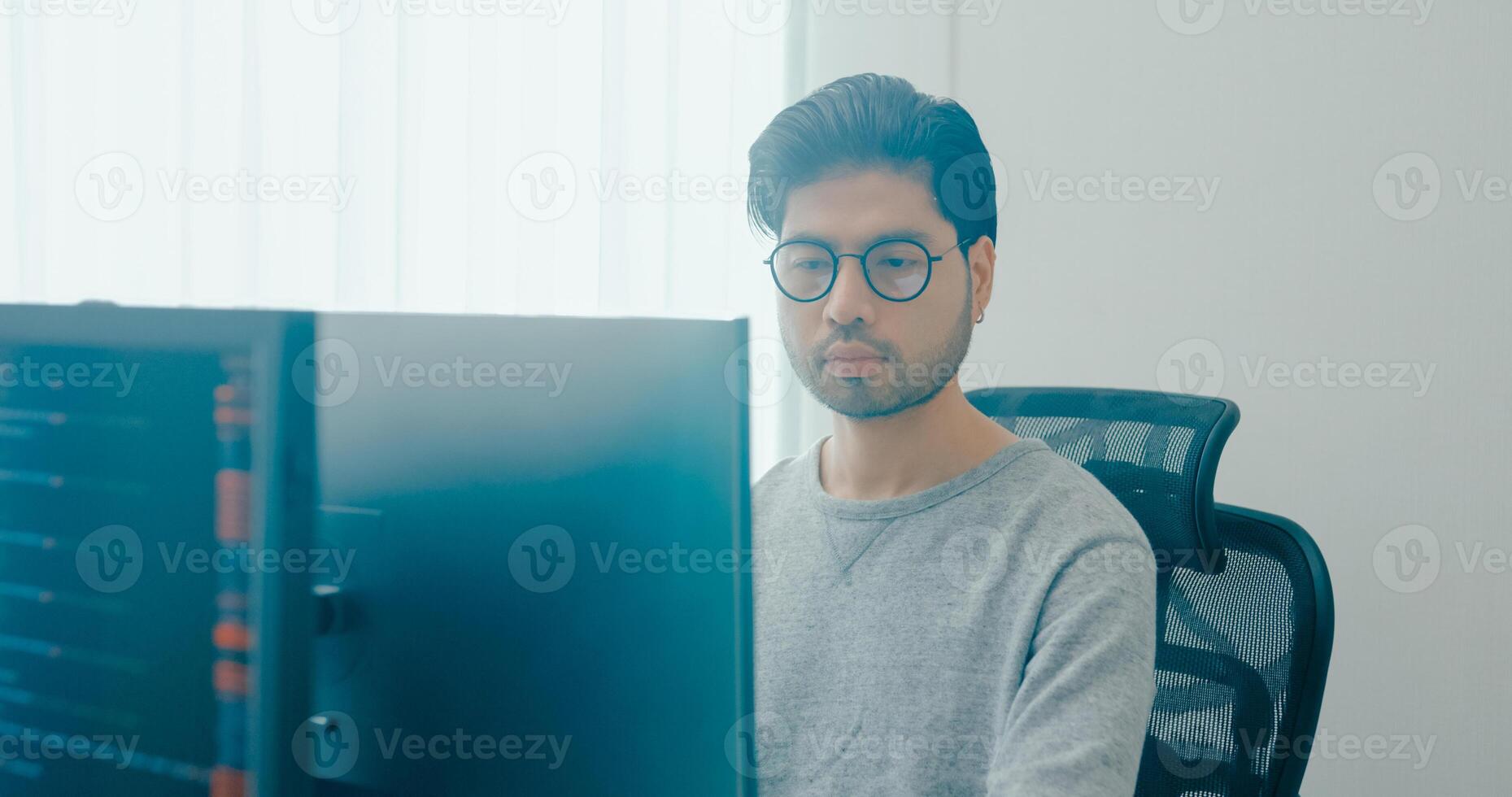 Young adult Asia male freelance eyeglasses typing write prompt AI bot IT app smart program nomad, game, terminal with coding, user interface, designer, big data center on desktop computer. photo