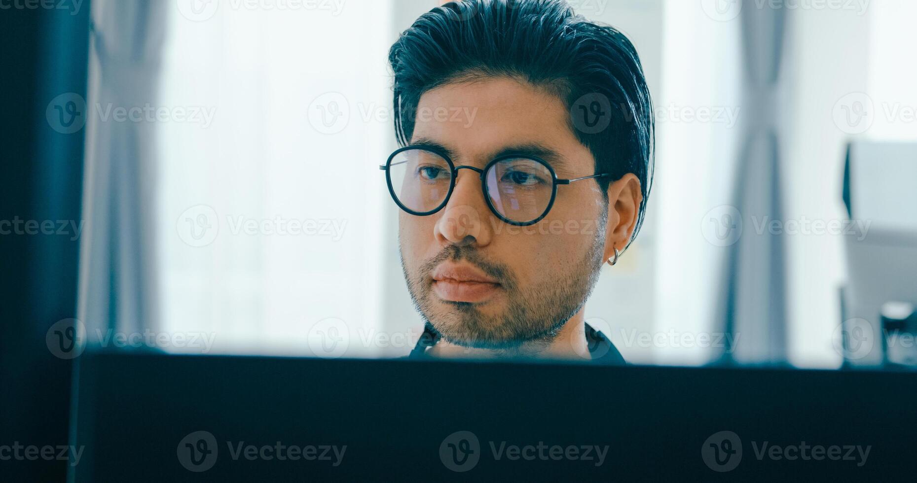 Closeup Asia male freelance eyeglasses typing write prompt AI bot IT app program nomad, game, terminal with coding, user interface, designer, big data center on desktop computer. photo