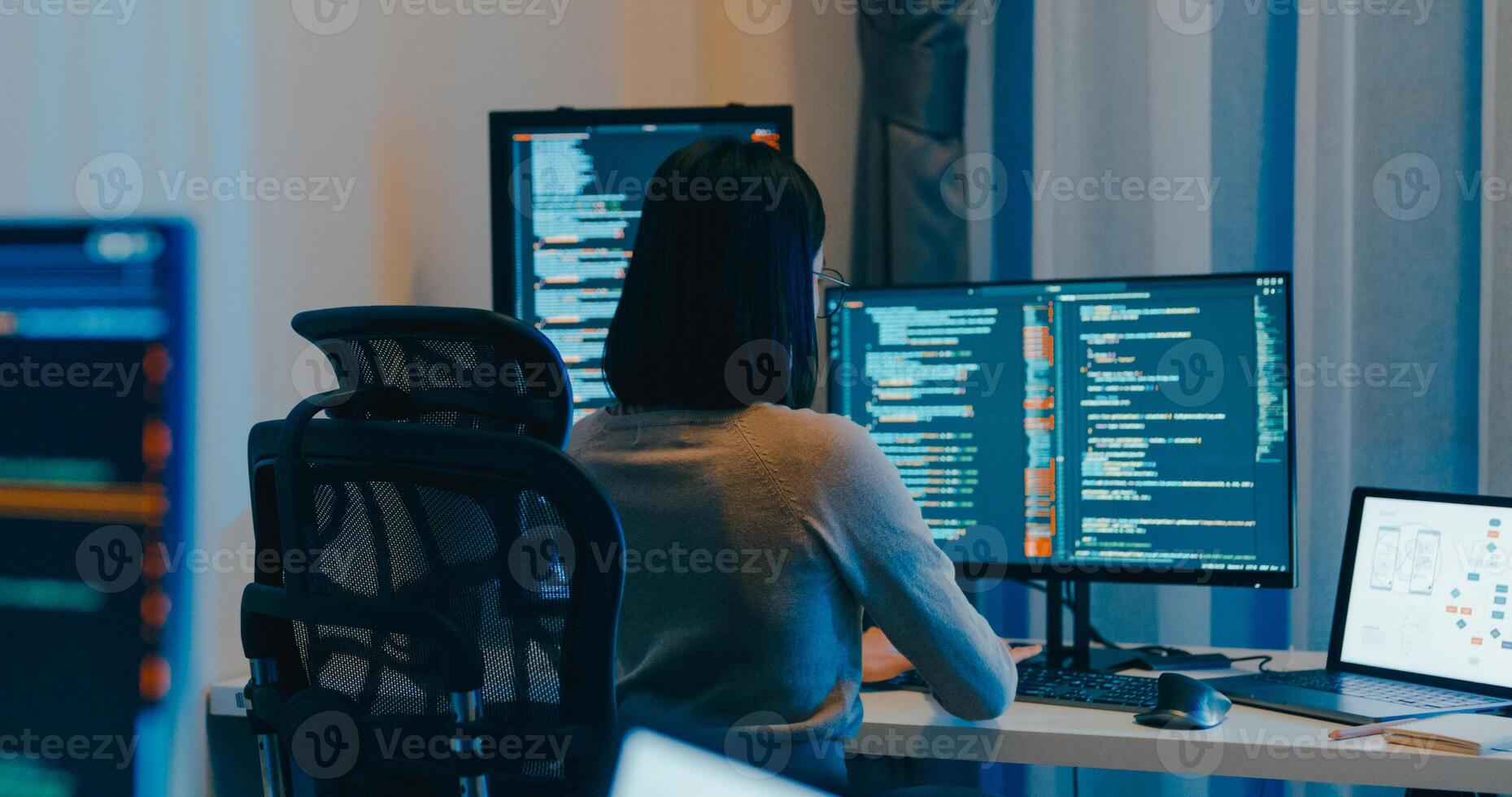 Young female freelance eyeglasses typing write prompt AI bot IT app smart program nomad, game, terminal with coding language, designer, big data center on desktop computer in night office. photo