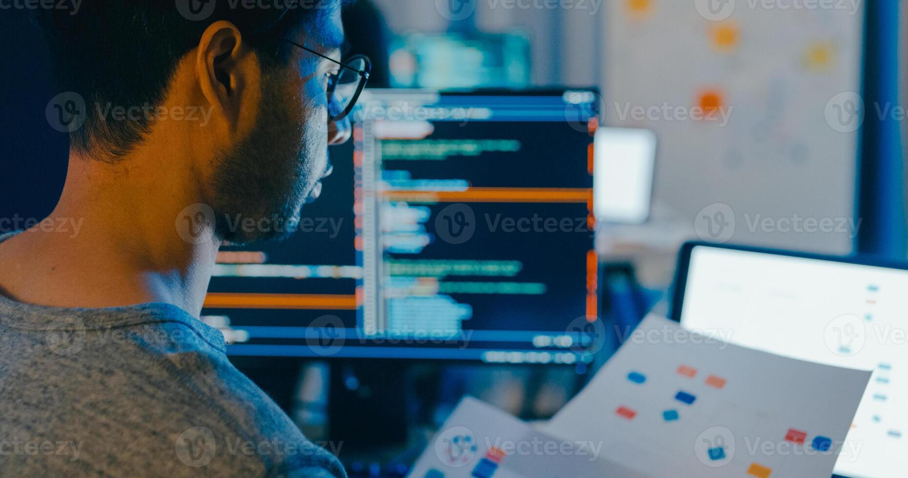 Closeup young adult Asia male typing write prompt AI bot IT app smart program nomad, game, terminal with coding language, designer, big data center on desktop computer in night office photo