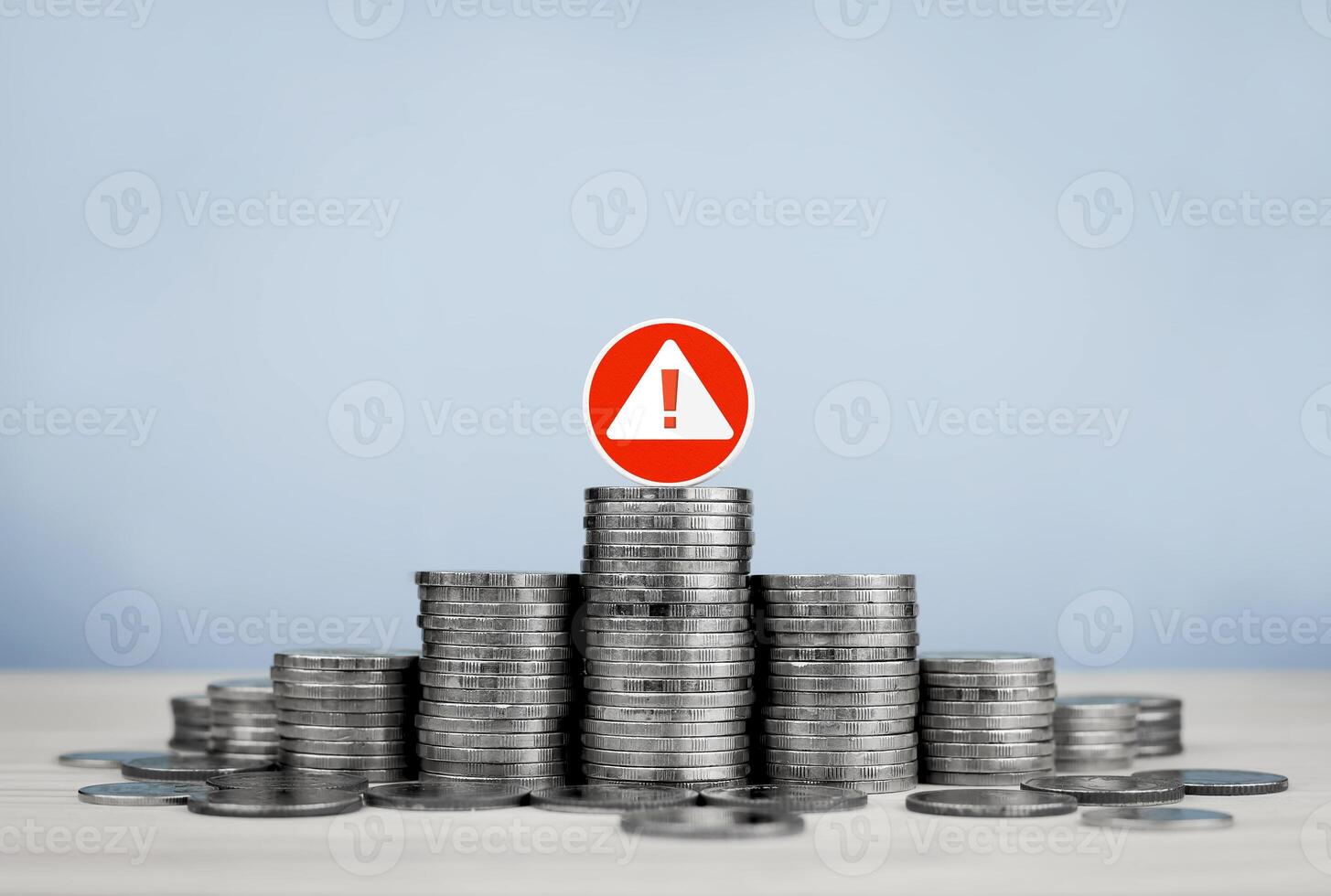 Stack of coins and red circle warning sign, with copy space. Concept of financial risk management, financial urgency, investment analysis and decision making. photo