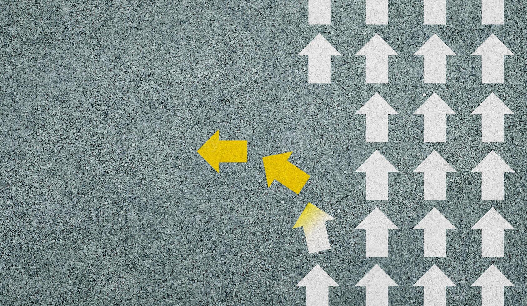 Concept of different business and decisions. Yellow arrow crossing direction, white arrow on asphalt road. With copy space. photo