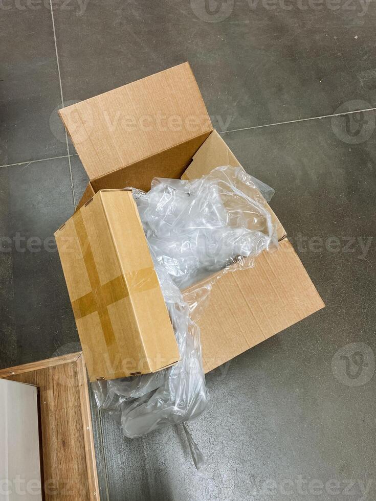 The shipping box contains tightly wrapped plastic that effectively ensures the items inside are wellprepared, safe, and protected during both shipping processes and storage periods photo